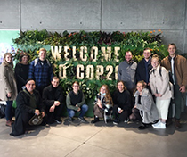 Photo of Schar School students in front of a COP26 sign in Scotland