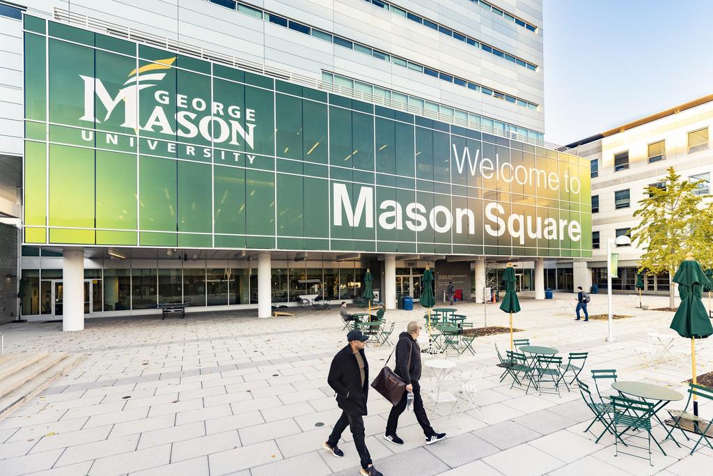 Students walking on the plaza at Mason Square