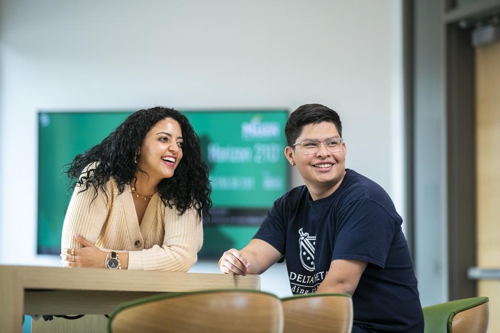 Two undergraduate students smiling